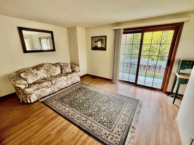 living area with wood finished floors and baseboards