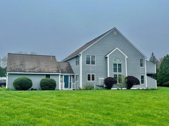 back of house with a lawn
