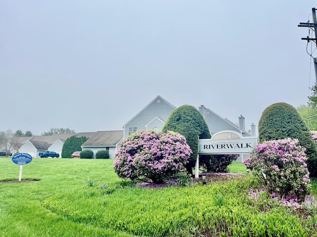 community sign featuring a lawn