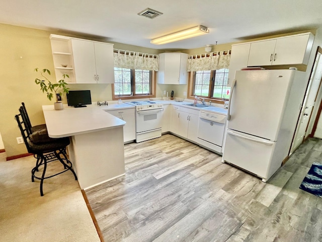 kitchen featuring a sink, a peninsula, white appliances, open shelves, and visible vents
