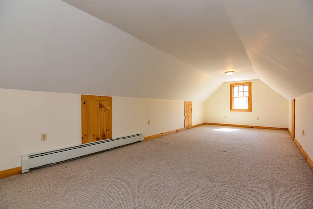 additional living space featuring baseboards, lofted ceiling, baseboard heating, and light colored carpet