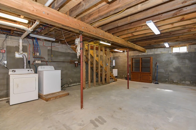 basement featuring stairs and washer and dryer