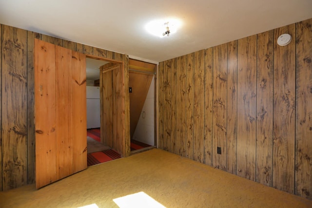 unfurnished room with wood walls