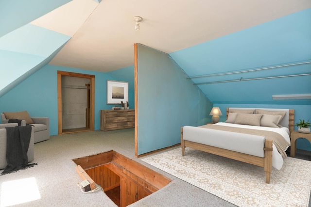 carpeted bedroom with lofted ceiling