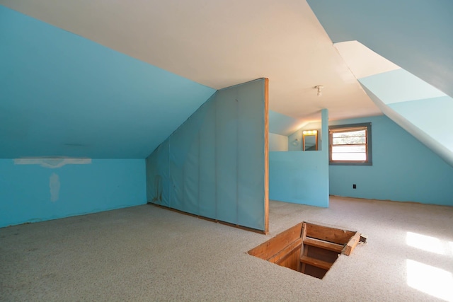 bonus room featuring lofted ceiling and carpet floors