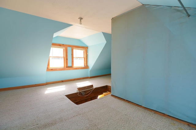 bonus room with vaulted ceiling, baseboards, and carpet floors
