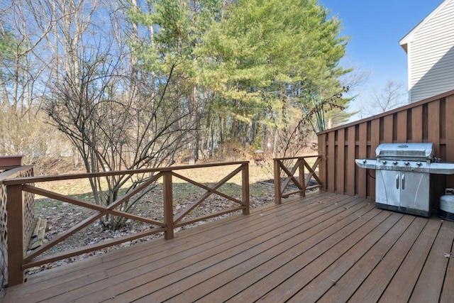 wooden deck featuring a grill