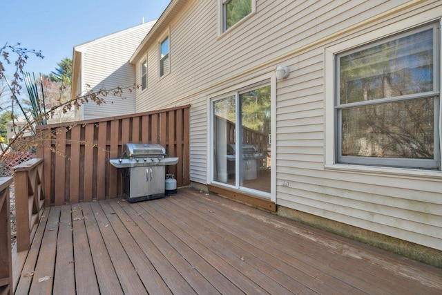 wooden deck with a grill