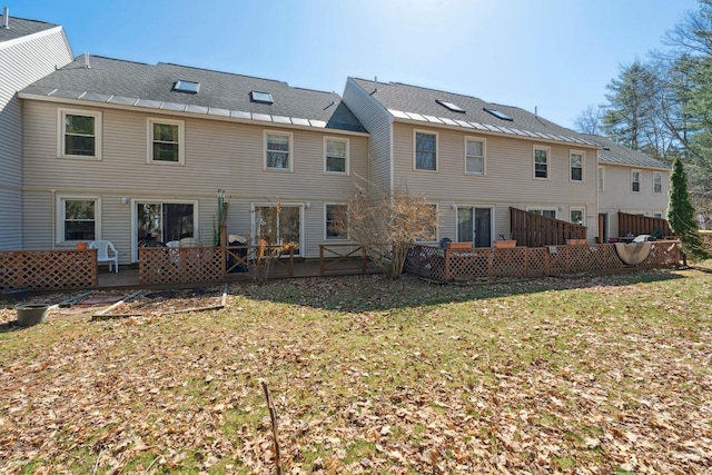 back of house featuring a lawn