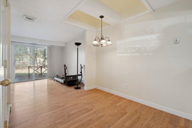dining area with baseboards, light wood-style flooring, visible vents, and a chandelier