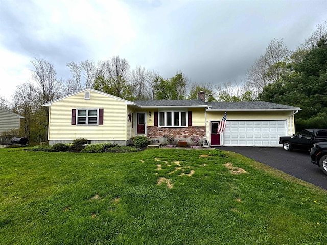 single story home with a chimney, driveway, brick siding, an attached garage, and a front yard