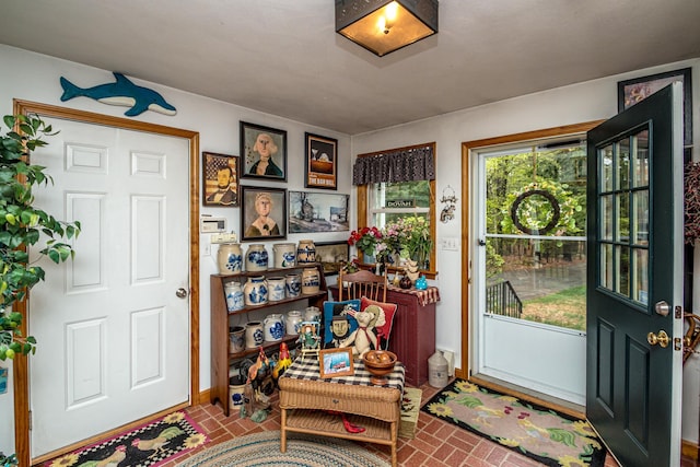 entrance foyer featuring baseboards and brick floor