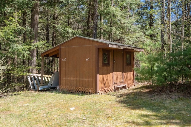 view of shed with a wooded view
