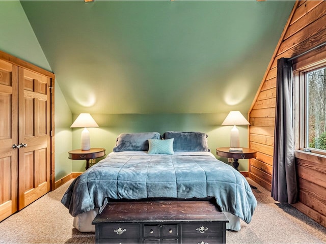 bedroom featuring lofted ceiling, carpet, and wooden walls