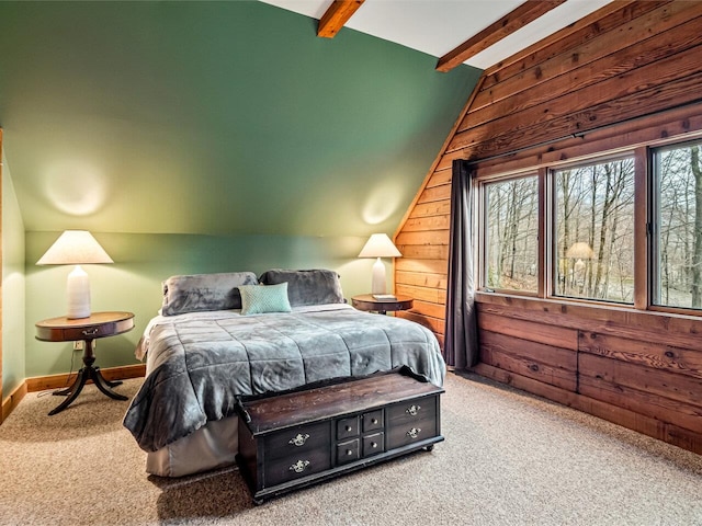 bedroom featuring baseboards, carpet flooring, wooden walls, and vaulted ceiling with beams