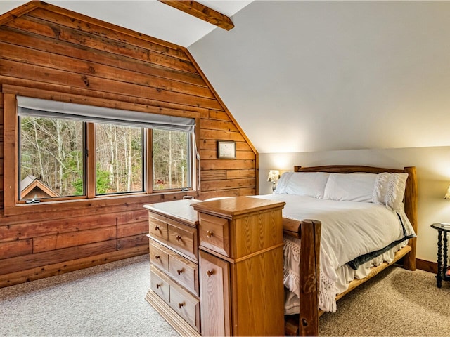 bedroom featuring light colored carpet, vaulted ceiling, and wooden walls
