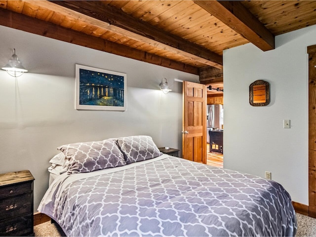 bedroom featuring wooden ceiling, stainless steel fridge, carpet floors, and beam ceiling