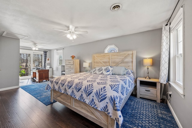 bedroom featuring wood finished floors, visible vents, baseboards, and a ceiling fan