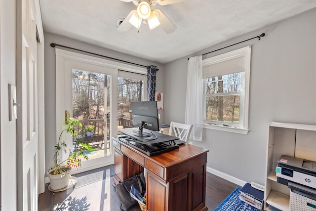 office space featuring dark wood-type flooring, baseboards, and ceiling fan