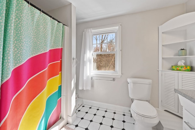 bathroom with a shower with curtain, toilet, baseboards, and tile patterned floors
