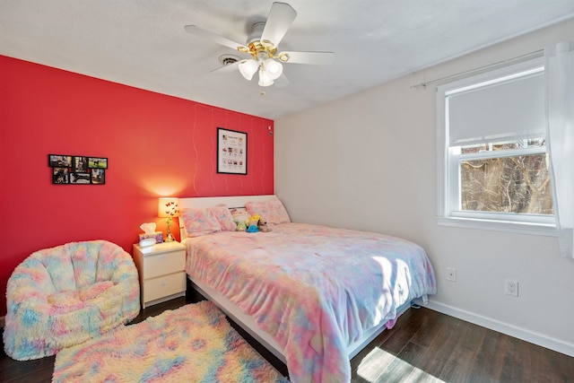 bedroom featuring a ceiling fan, wood finished floors, and baseboards