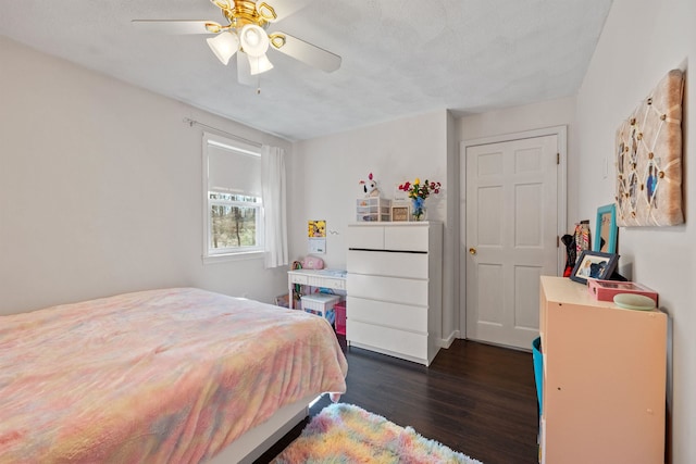 bedroom with dark wood-type flooring and ceiling fan