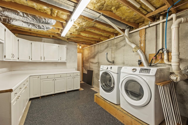 clothes washing area with cabinet space and washing machine and clothes dryer