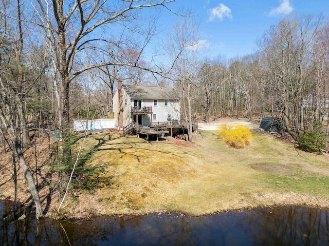 view of yard featuring a deck with water view