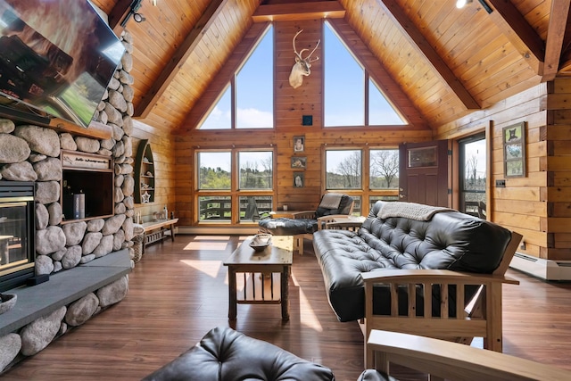 93 Roller Coaster Rd, Laconia, NH 03246 - living area featuring rail lighting, wood walls, wood ceiling, a stone fireplace, and high vaulted ceiling
