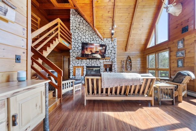 93 Roller Coaster Rd, Laconia, NH 03246 - bedroom featuring wood ceiling, wooden walls, a fireplace, wood finished floors, and beamed ceiling