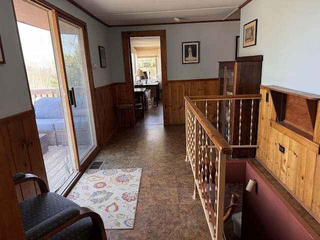 60 Effingham Rd, Ossipee, NH 03864 - hallway with wainscoting, wood walls, an upstairs landing, stone finish floors, and crown molding