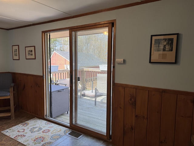 60 Effingham Rd, Ossipee, NH 03864 - doorway with a wainscoted wall, crown molding, and wooden walls