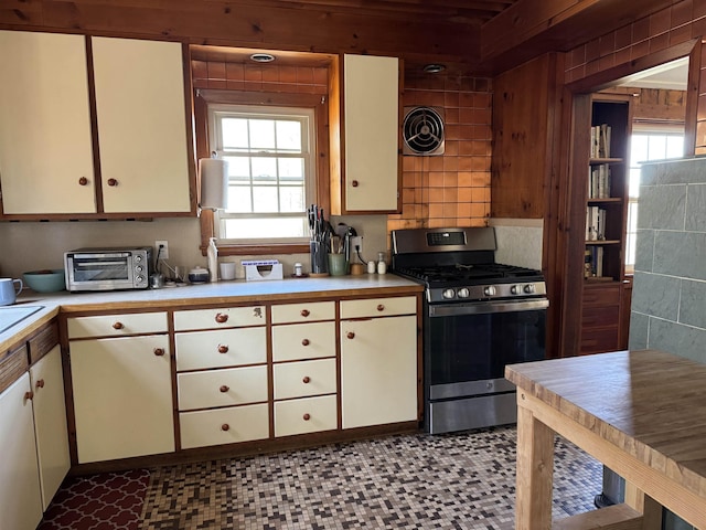60 Effingham Rd, Ossipee, NH 03864 - kitchen with stainless steel gas range, light countertops, healthy amount of natural light, and light flooring