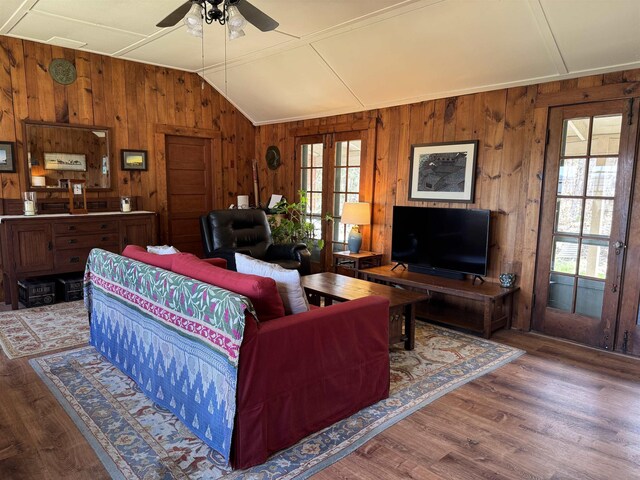 60 Effingham Rd, Ossipee, NH 03864 - living room with healthy amount of natural light, wooden walls, vaulted ceiling, ceiling fan, and wood finished floors