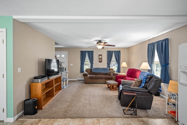 living area featuring baseboards, a baseboard radiator, a ceiling fan, and carpet floors