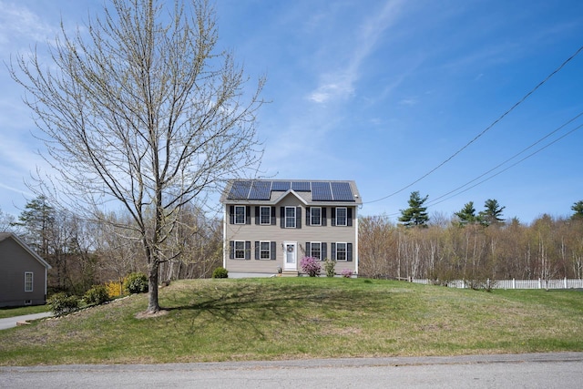 view of front facade featuring solar panels