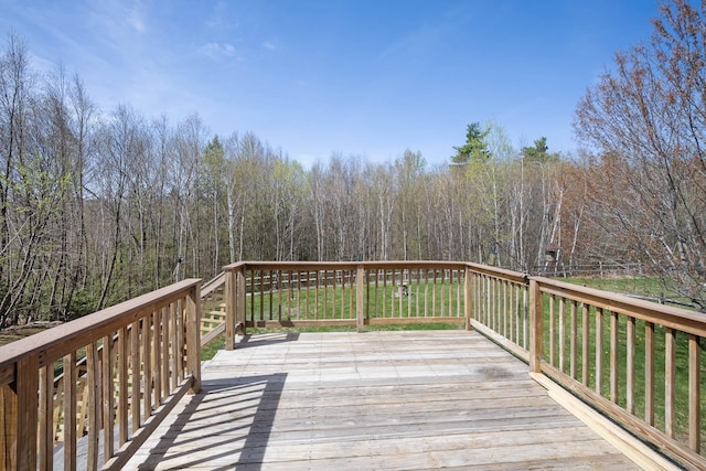 wooden deck with a view of trees