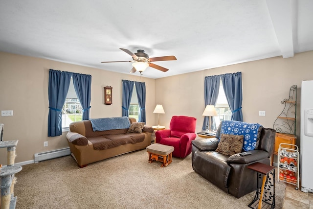 living area with a baseboard heating unit, plenty of natural light, a ceiling fan, and carpet flooring