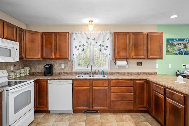 kitchen with white appliances, a sink, brown cabinets, recessed lighting, and tasteful backsplash