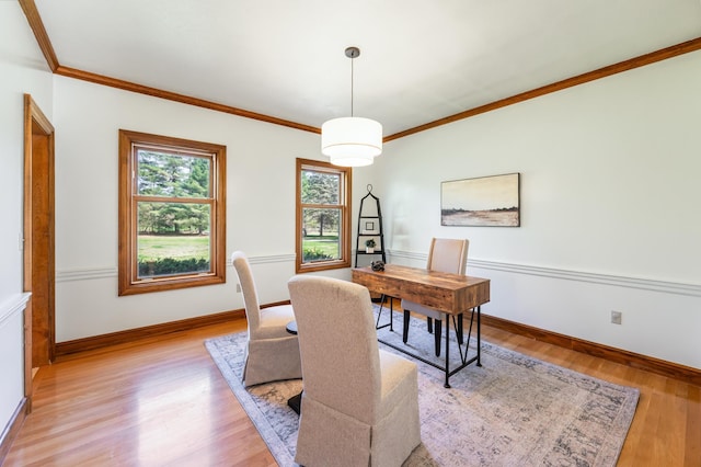 office area featuring crown molding, light wood-type flooring, and baseboards