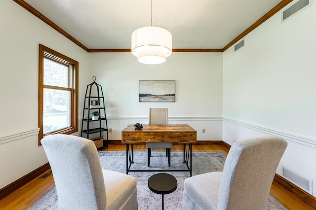 home office with crown molding, wood finished floors, and baseboards