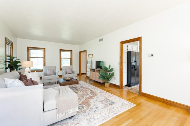 living room with light wood-type flooring and baseboards