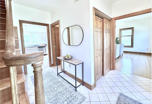 hallway featuring light tile patterned flooring and baseboards