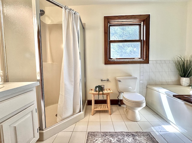 full bath featuring a stall shower, toilet, tile patterned flooring, vanity, and a bath