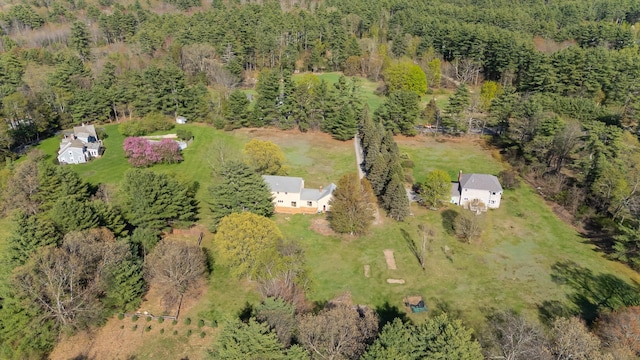 aerial view of property and surrounding area with a heavily wooded area
