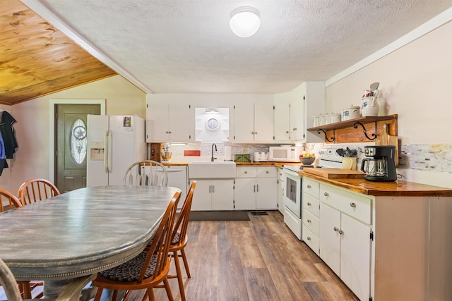 kitchen featuring white appliances, open shelves, white cabinets, backsplash, and wood finished floors