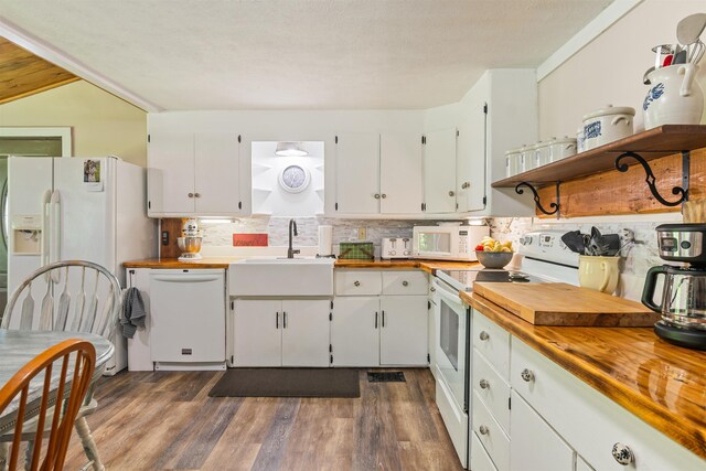 kitchen featuring white appliances, butcher block counters, a sink, and open shelves