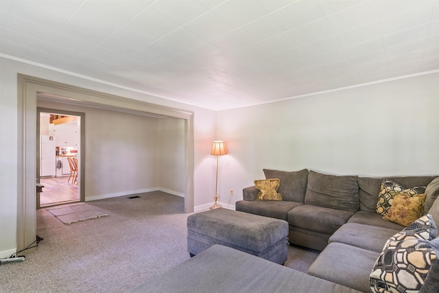 living room featuring carpet floors, crown molding, and baseboards