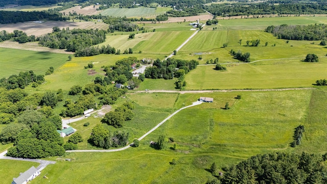 aerial view of property and surrounding area featuring rural landscape, a pastoral area, and a tree filled landscape
