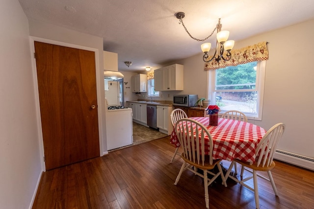 dining space with a chandelier and hardwood / wood-style flooring